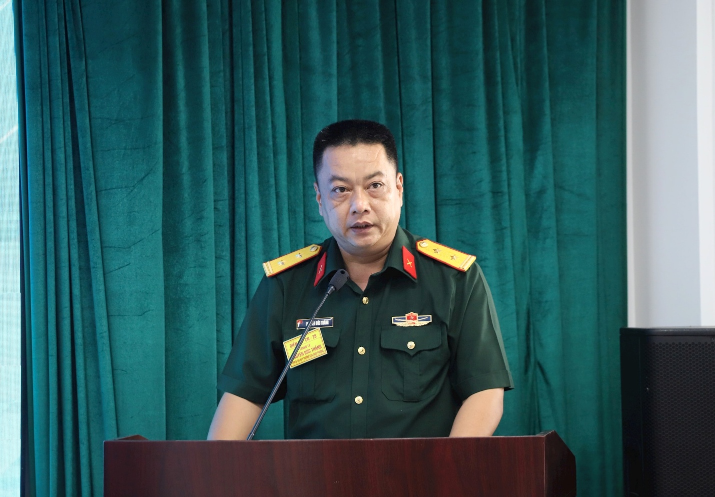 A person in uniform standing at a podium  AI-generated content may be incorrect.