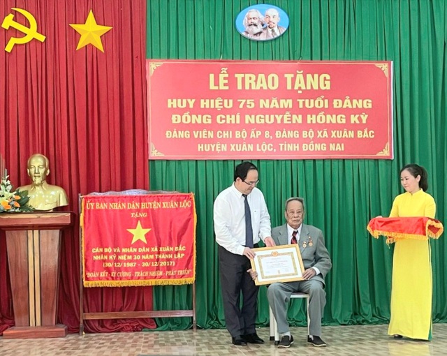 Ông Quản Minh Cường - Phó Bí thư tỉnh ủy, Trường đoàn đại biểu quốc hội tỉnh Đồng Nai trao huy hiệu 75 tuổi Đảng trước thời hạn cho ông Nguyễn Hồng Kỳ.
