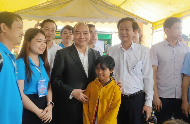 Chủ tịch nước Nguyễn Xuân Phúc ân cần thăm hỏi, động viên em học sinh cố gắng chăm ngoan học giỏi.