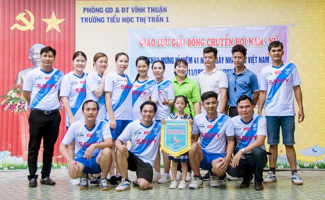 Đội bóng chuyền hơi Hội cha mẹ học sinh Trường Tiểu học thị trấn 1 chụp ảnh lưu niệm với Ban tổ chức và tổ trọng tài hội thao.