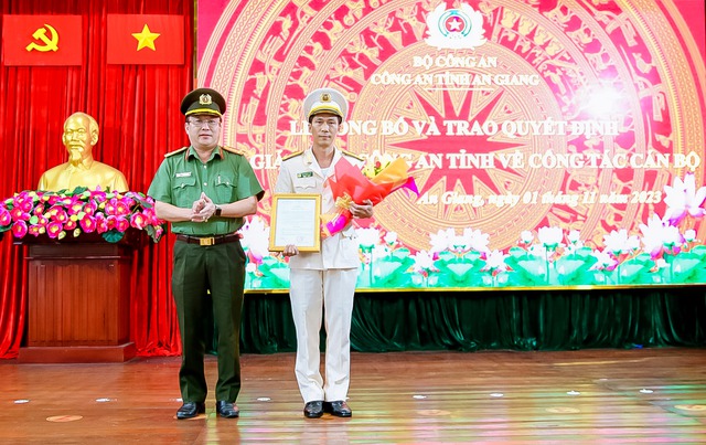 Đại tá Lâm Phước Nguyên, Bí thư Đảng ủy, Giám đốc Công an tỉnh trao quyết định và tặng hoa chúc mừng Thượng tá Phạm Hoàng Tùng.