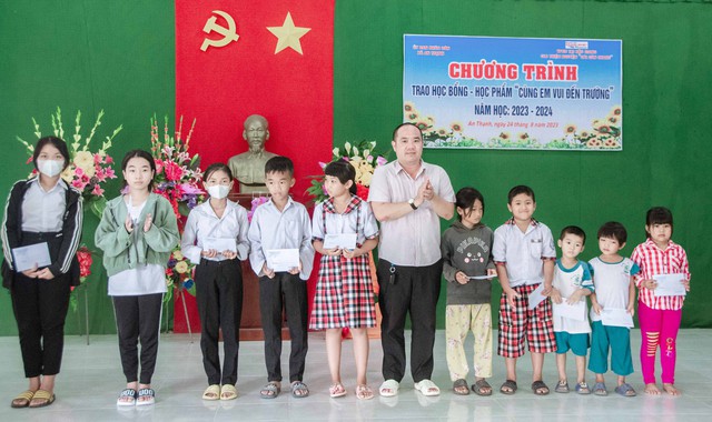 Ông Nguyễn Hồng Ân, Trưởng VPĐD Tạp chí Doanh nghiệp và Tiếp thị tại Hậu Giang trao học bổng cho các em học sinh.