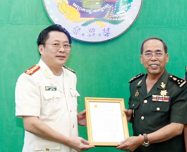 Đại tá Lâm Phước Nguyên, Giám đốc Công an tỉnh An Giang trao thư chúc Tết cho Đại tướng Dieng Sa Run, Phó Tư lệnh, Bộ tư lệnh Cảnh vệ Quân đội Hoàng gia Campuchia